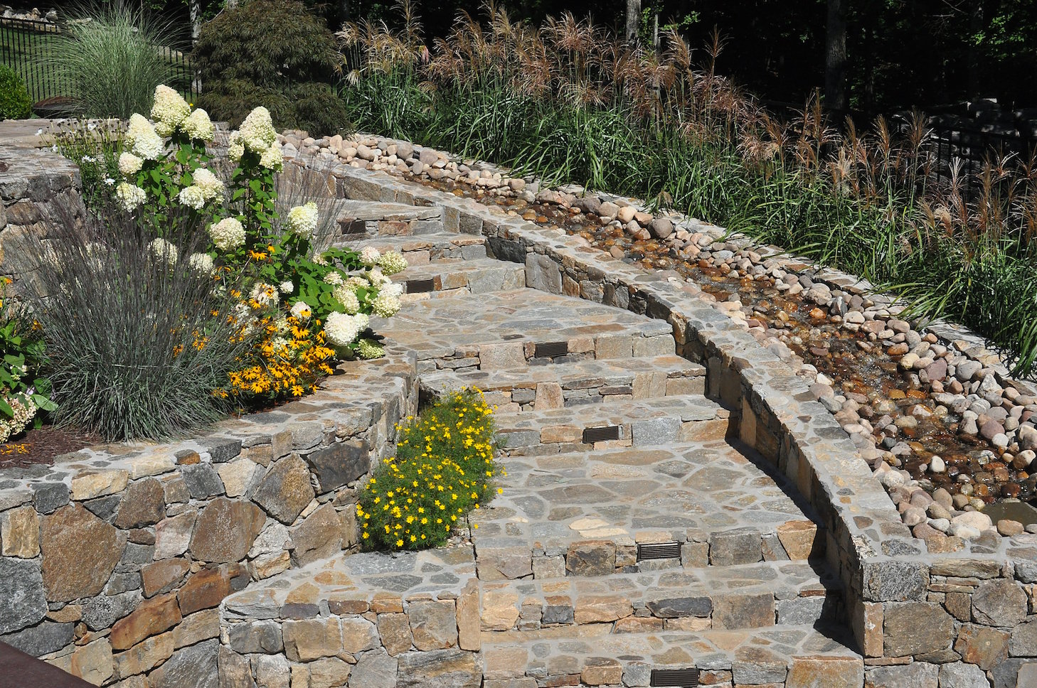 Residential water feature installation providing movement and visual emphasis